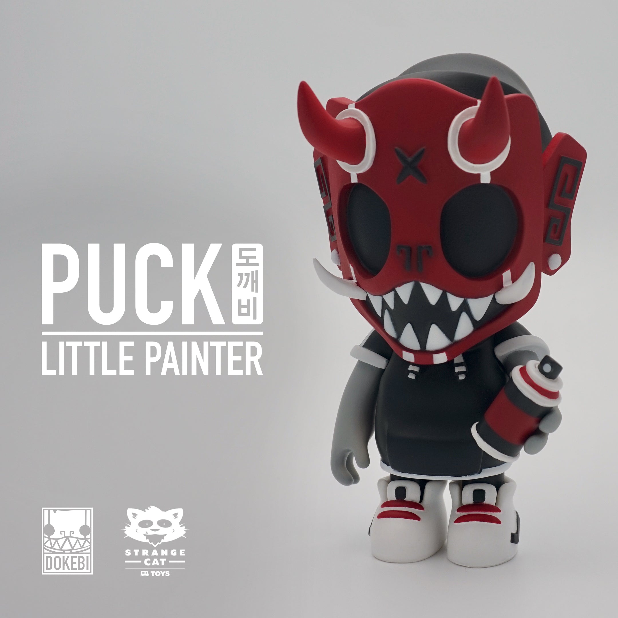 A toy figure with a red mask and white teeth, part of the Puck - Little Painter OG Red by Chris Dokebi collection.