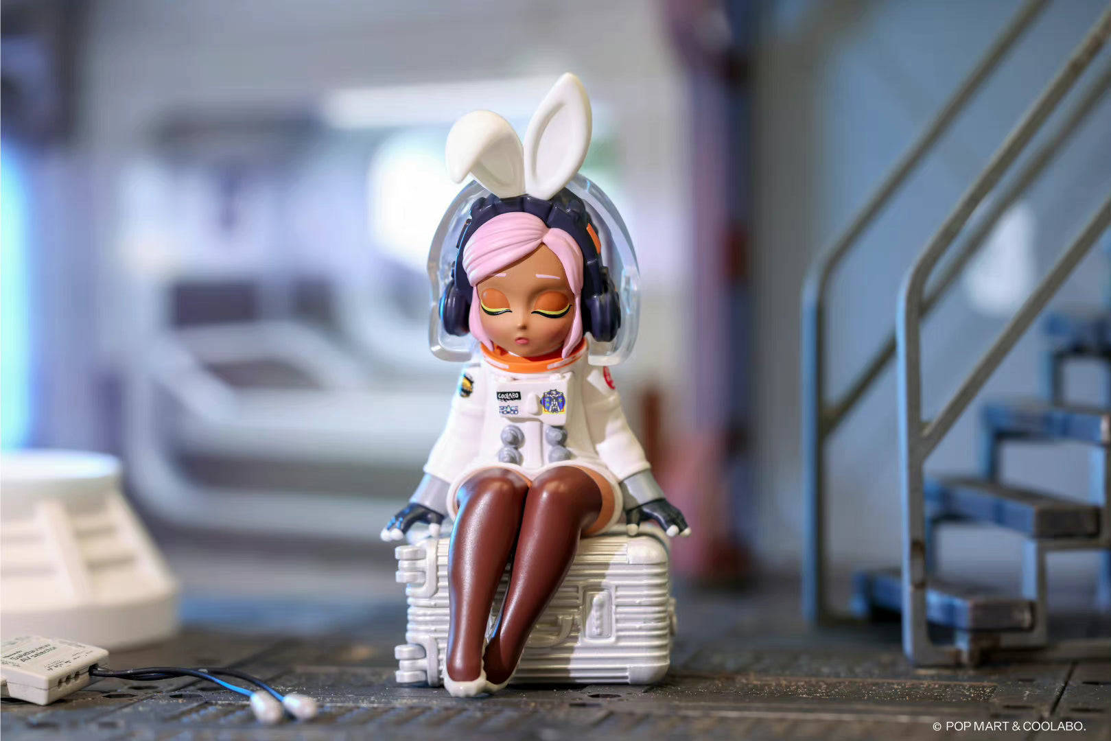 A toy figurine of a girl in a space suit and headphones from the spaceHOOD Blind Box Series by Coolabo.