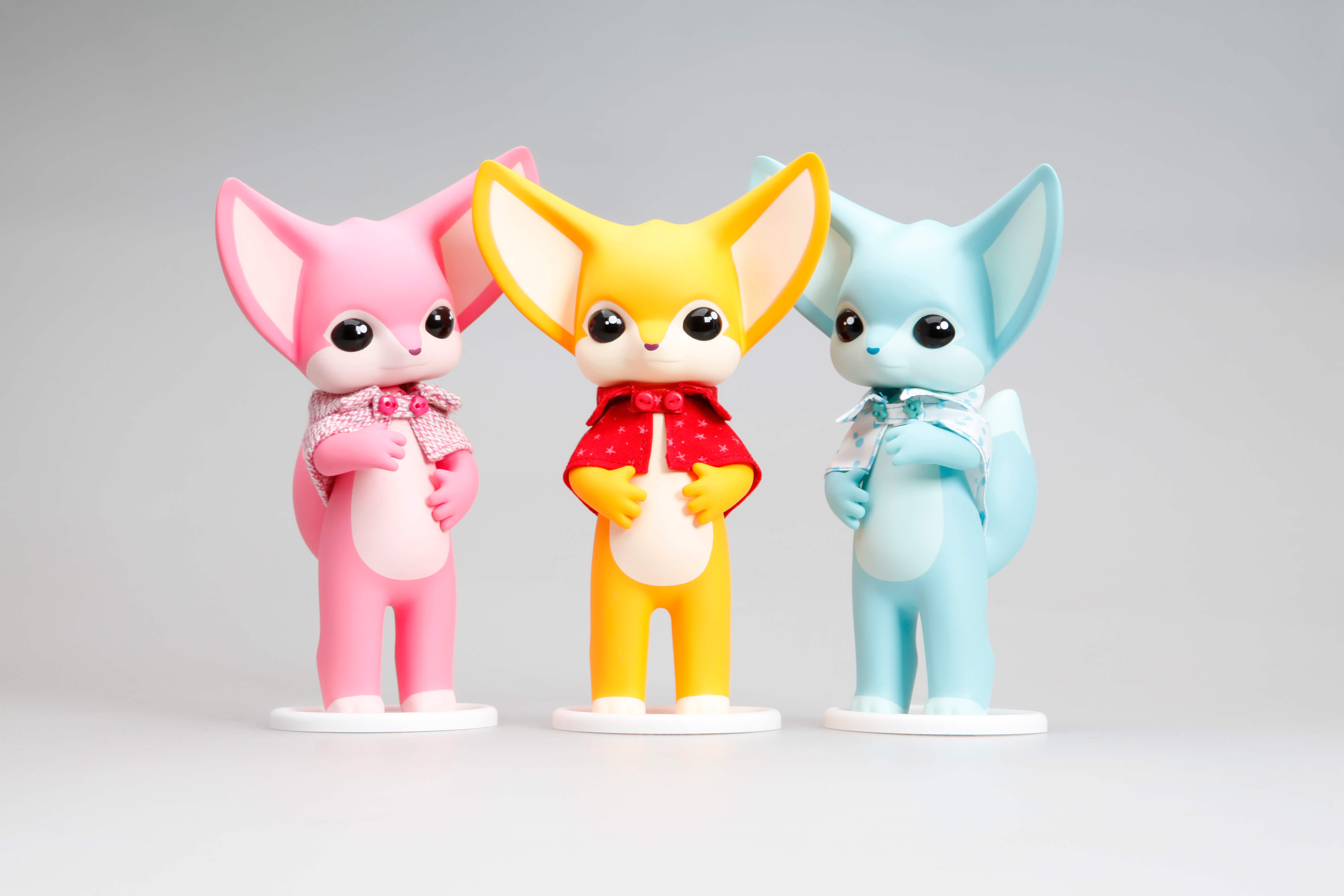 Toy vinyl figurine of Fennec Fox Dona by twelveDot surrounded by animal figures and cartoon characters.