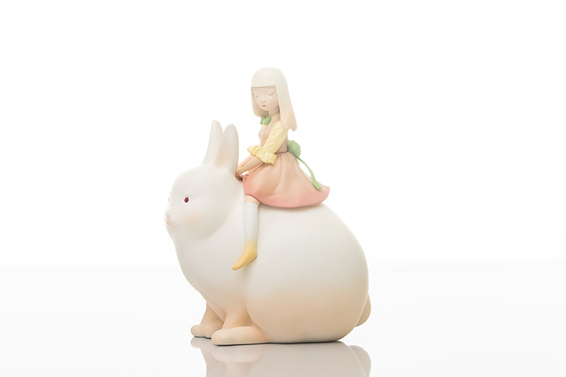 A toy figurine of a girl riding a rabbit, created by Steven Jia, from Strangecat Toys.