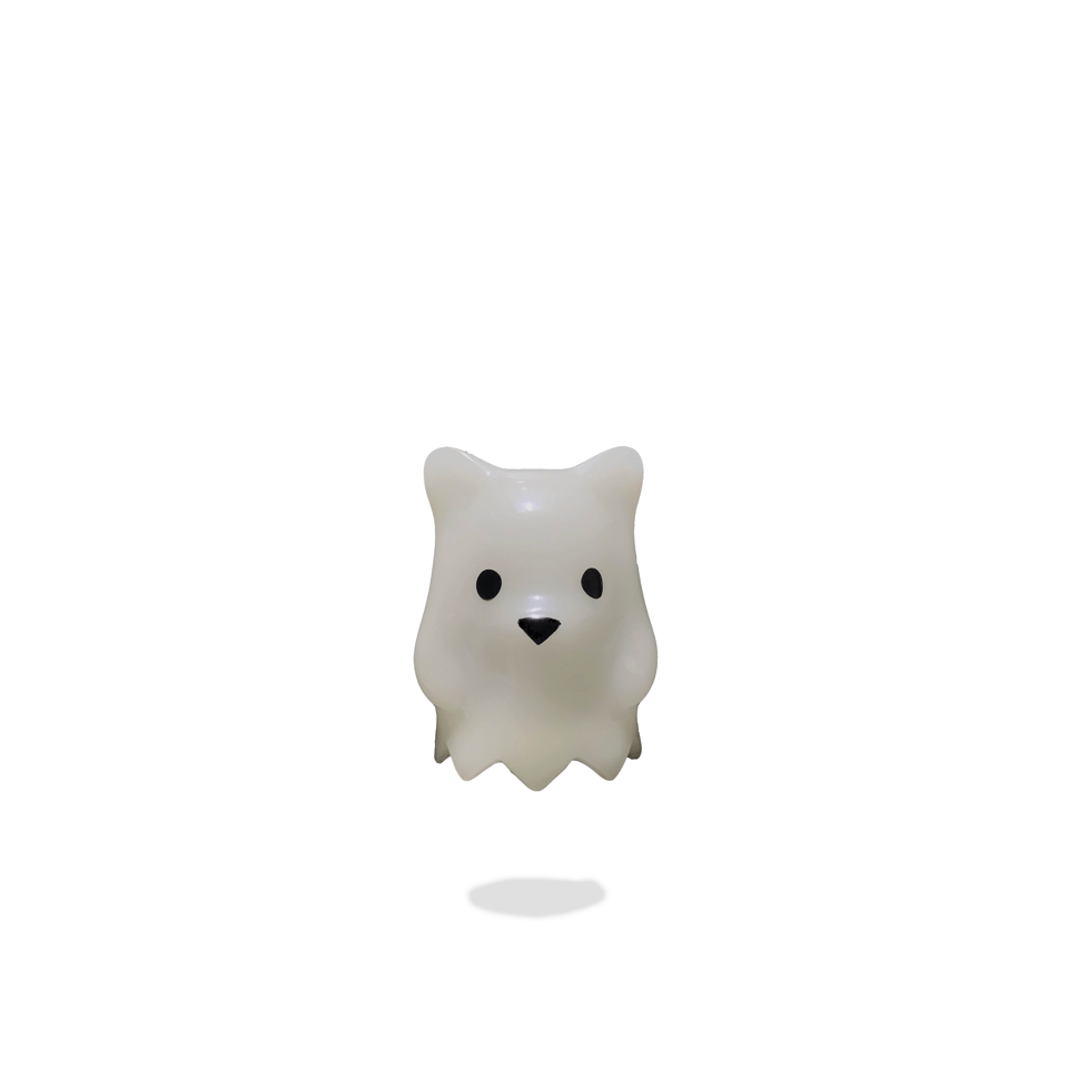 A small vinyl toy of Ghostbear, a white bear character with black eyes, inspired by a web comic by Luke Chueh.