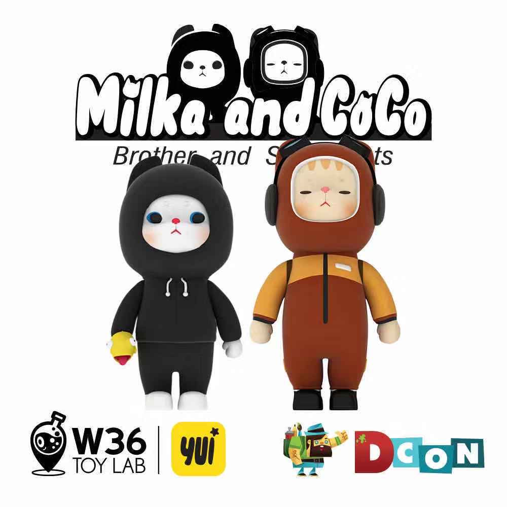 Milka & Coco - Brother and Sister Cats by YUi, a set of two toys, one in a garment, one with a beard and hat, and a cartoon cat face on a square object.