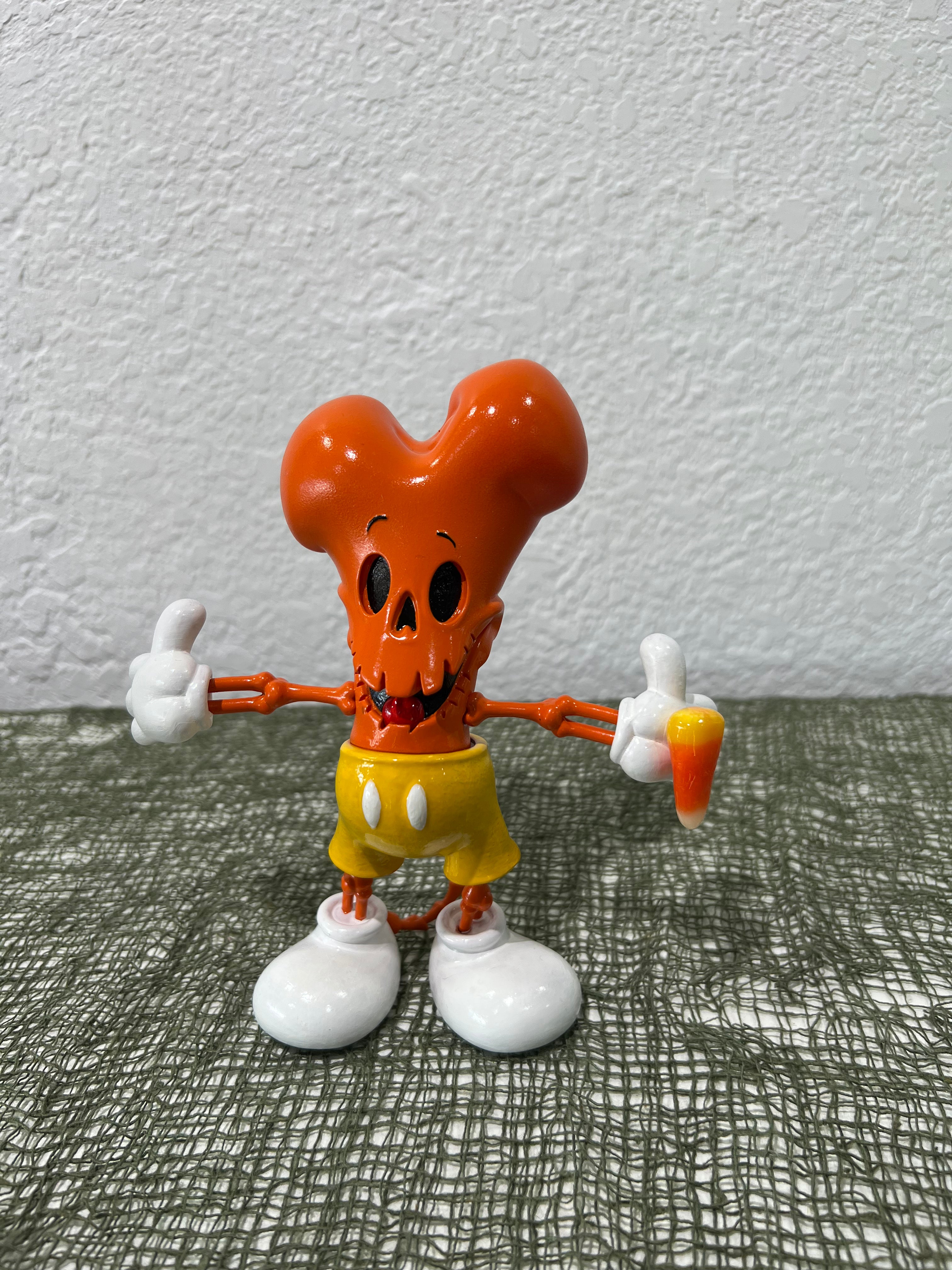 Toy figurine of a cartoon character with legs and arms, part of Strangecat's Halloween Show 2 by Murderbird.