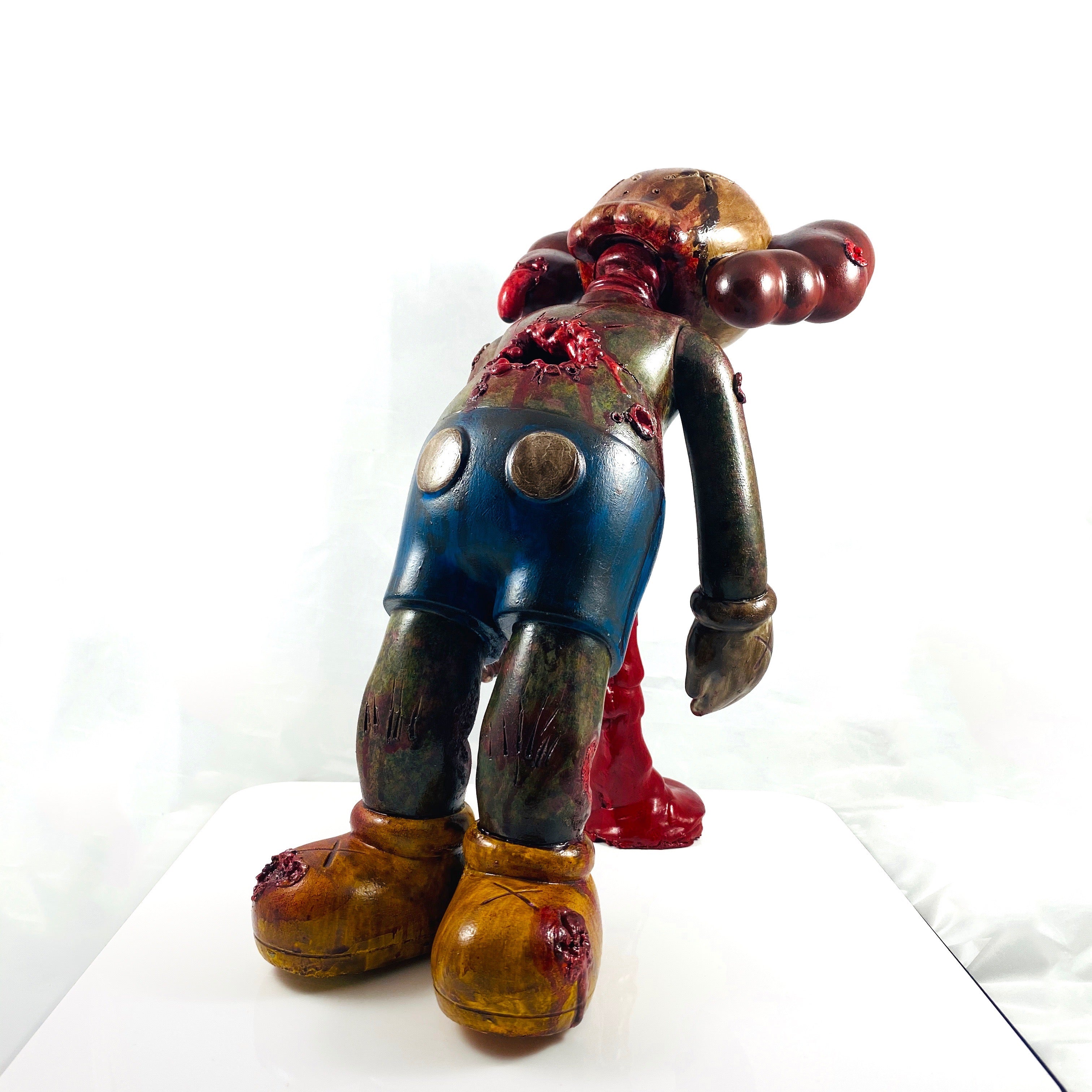 Custom 16 Kaws Companion figurine, Misappropriated Icon 3 - Cause I'm Dead By Red Guardian, featuring a statue of a man with blood on his body.