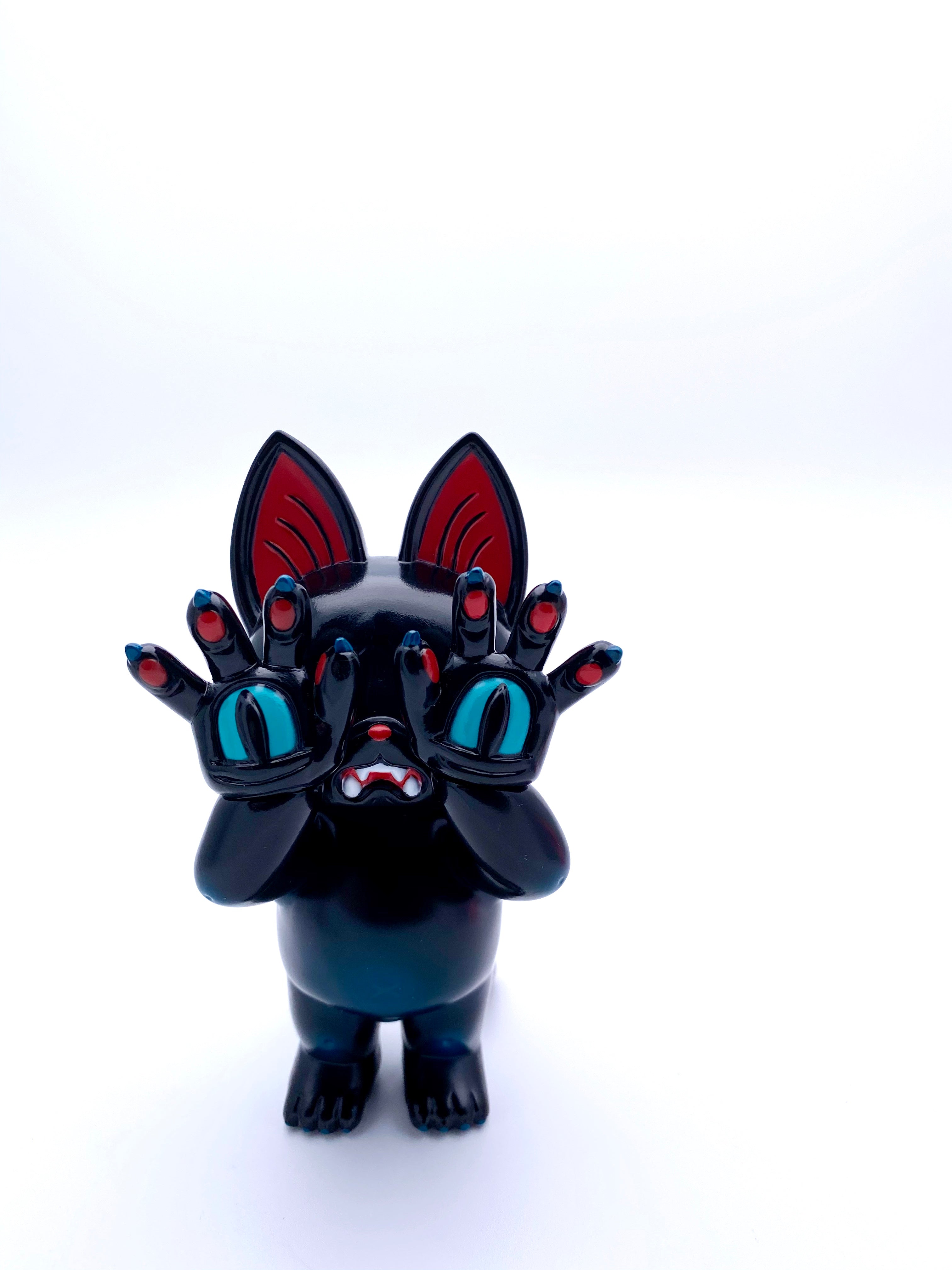 A Japanese soft vinyl toy of ONIGIRI - Black by Grape Brain, featuring a black cat figurine with red ears and hands.