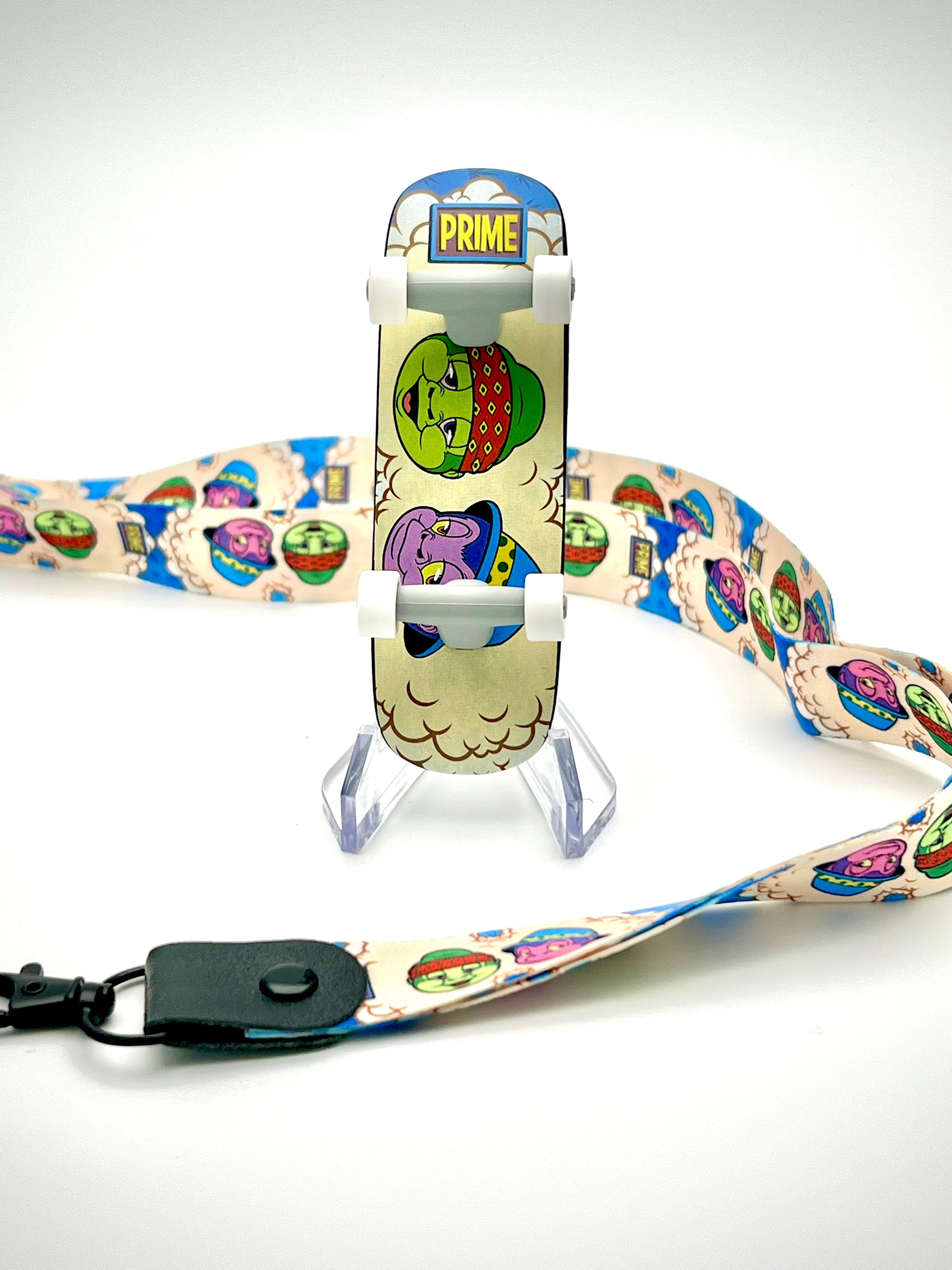 Art Decks - In Prime We Trust skateboard with cartoon characters, lanyard, and connector on stand.