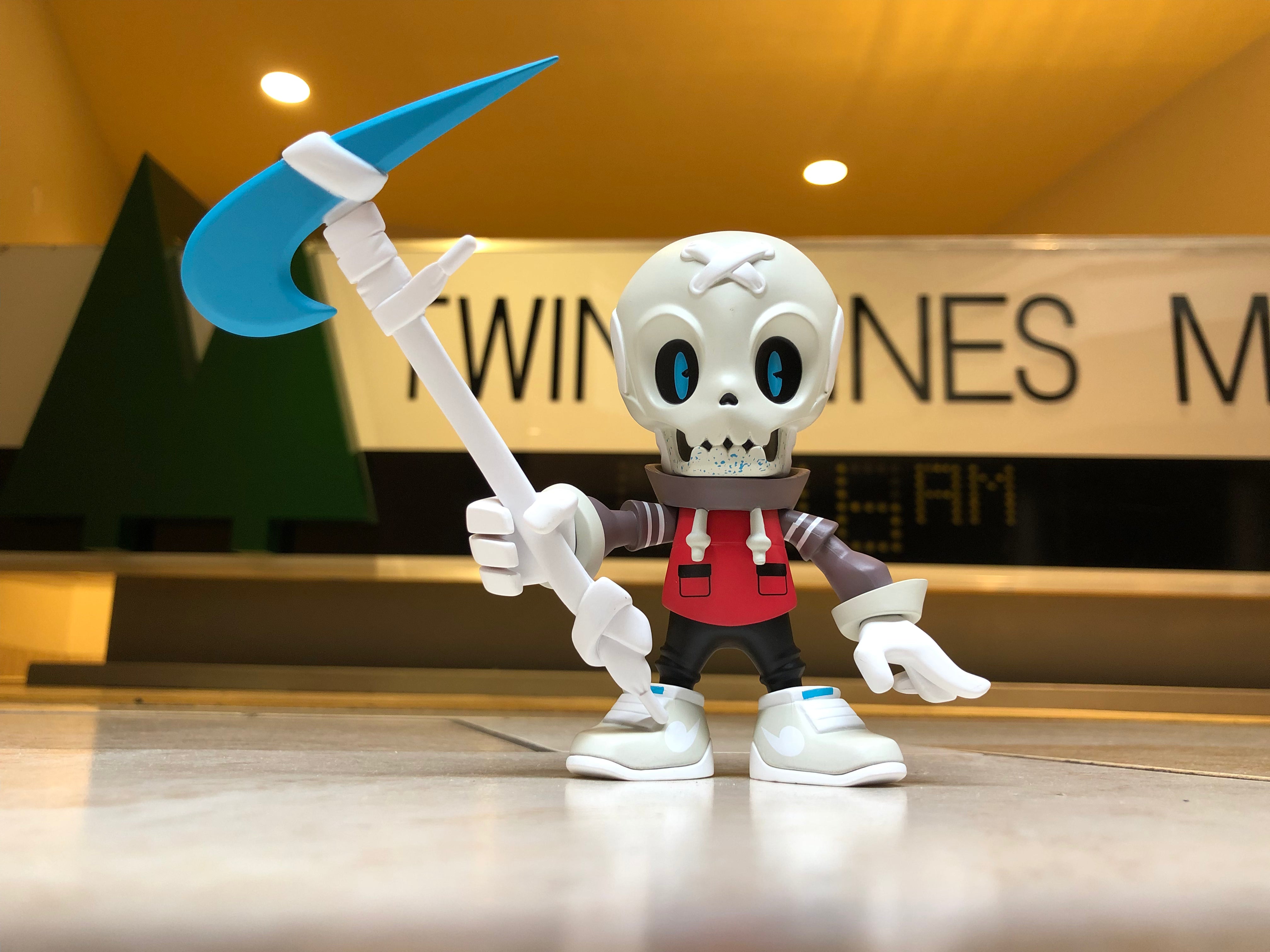 Action figure toy holding scythe, white skull detail, and blue axe, part of Ded Stock - Air Mag 90 Edition by KwestOne.