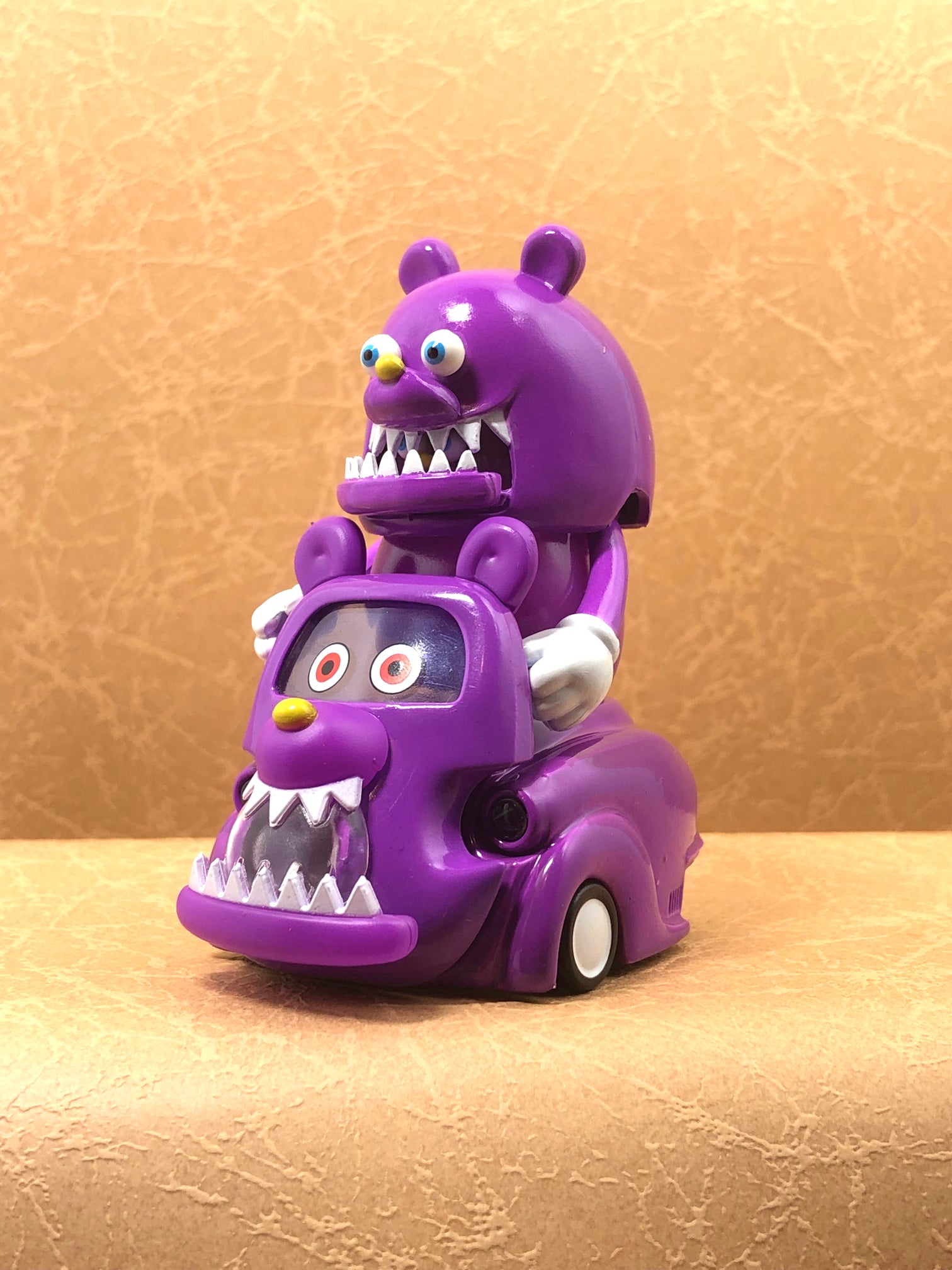 Toy car with cartoon character and monster, part of Lumisofvi T9G KOTARO Purple Car set.