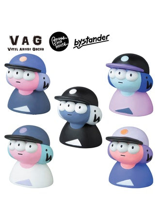 VAG 23 - Bystander toy figurines, including a person wearing a hat and a cartoon character, part of a group of small toys.