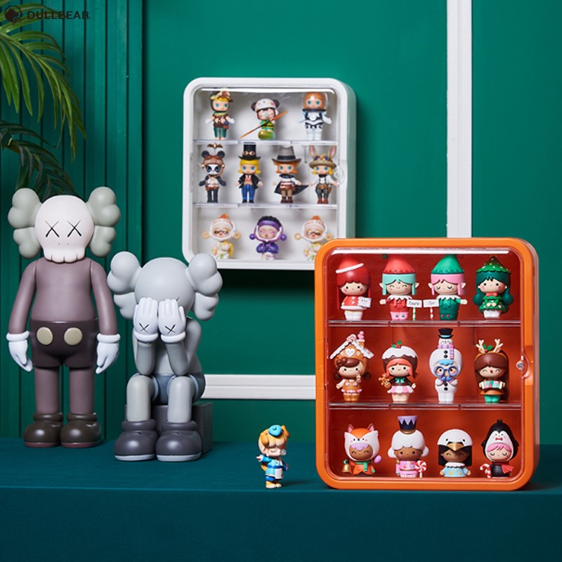 Toy Display Case (Wall) showcasing a group of toys, a doll, and a leaf up close. Waterproof/Dustproof, 31cm x 27cm x 12cm, includes wall mount.