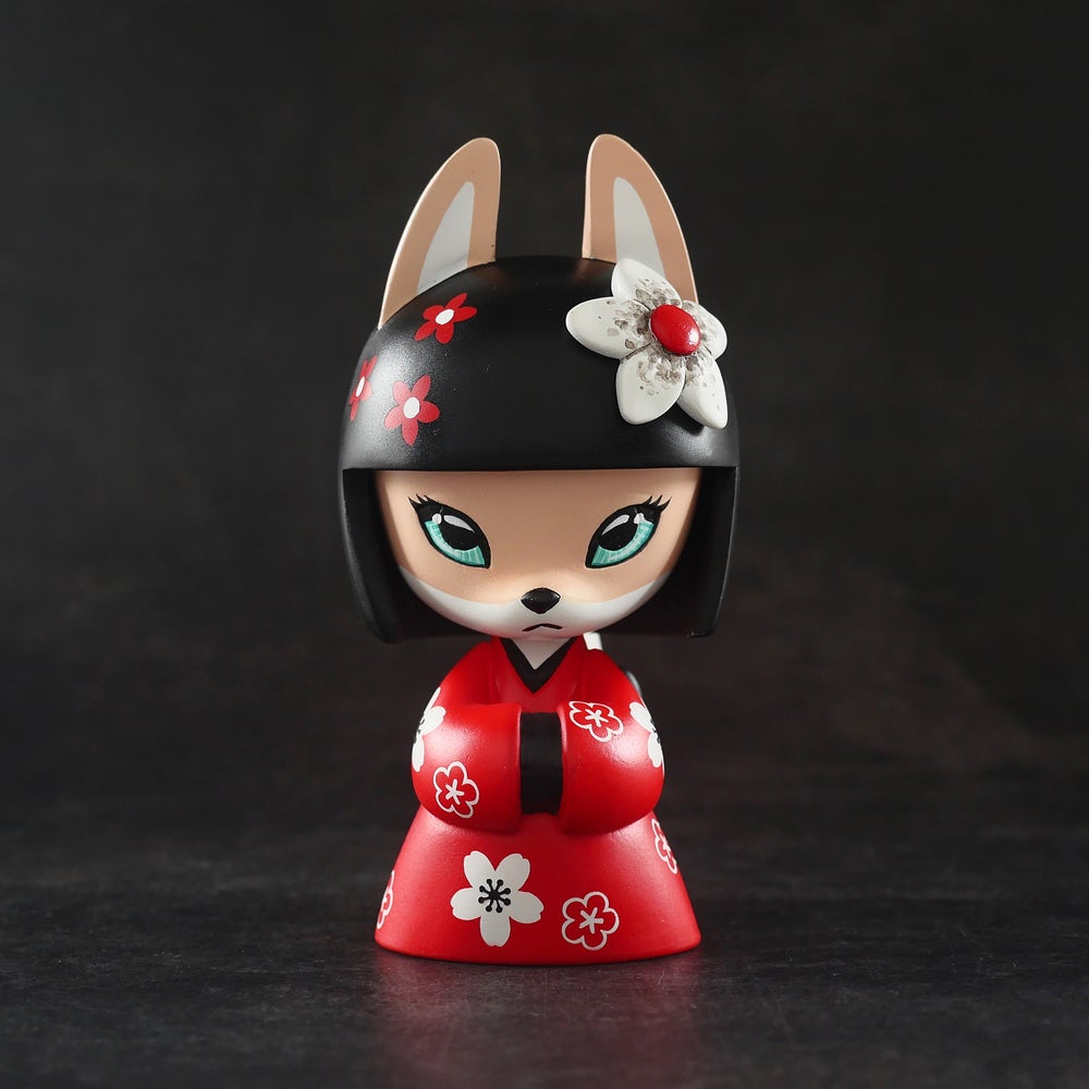 Yukachan figurine by Otto Bjornik, a small resin toy of a girl with a hat, flowers, and a red dress.