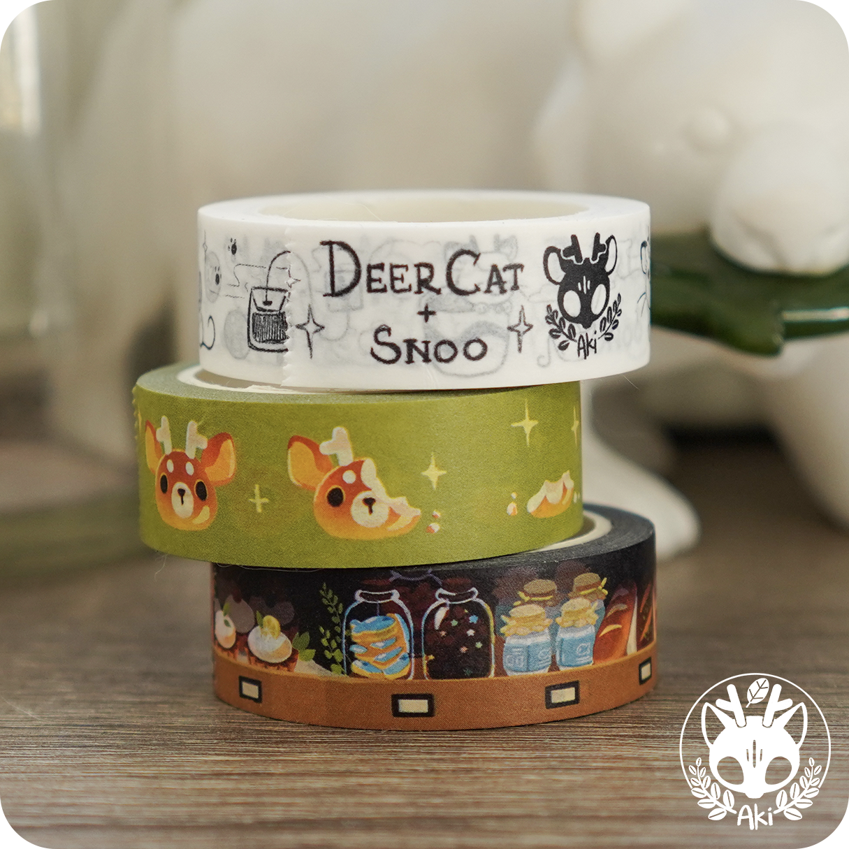 DeerCat Cafe - Washi Tape featuring a stack of tape rolls with cartoon animals and images on them.