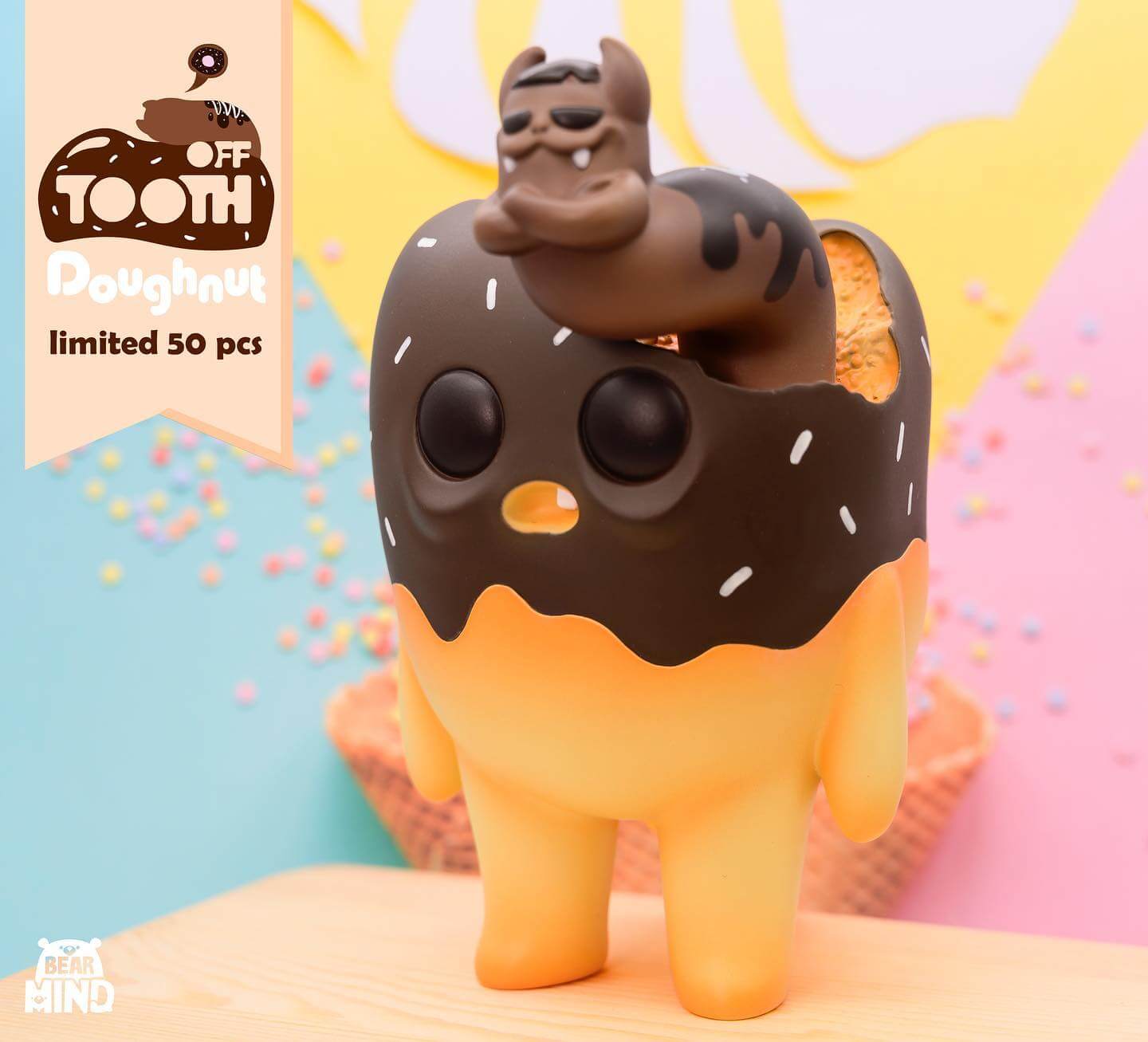 Toy figurine of a crocodile wearing a doughnut hat emerging from an egg, part of the limited edition Tooth off - Doughnut Tooth collection by Bear In Mind Toys.