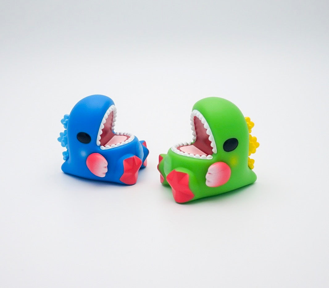 Unbox & Friends Dino Event Exclusive Set by Ziqi wu: Blue and green dinosaur toys with open mouths, black circle detail.