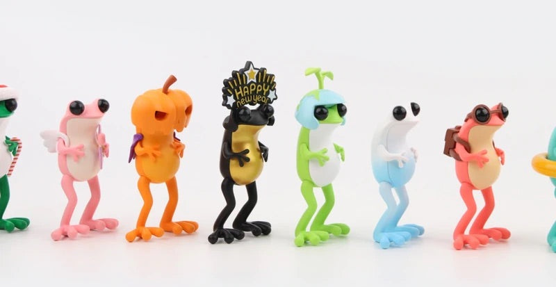 A group of small toys featuring various animal figures from the APO Frogs 12 Months Blind Box Series by Twelvedot.
