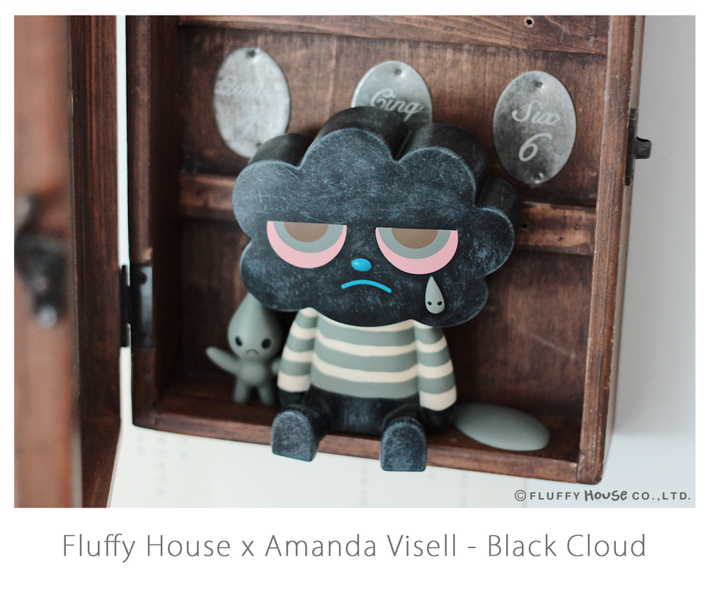 A toy in a wooden box, part of FLUFFY HOUSE X AMANDA VISELL SERIES - BLACK CLOUD.