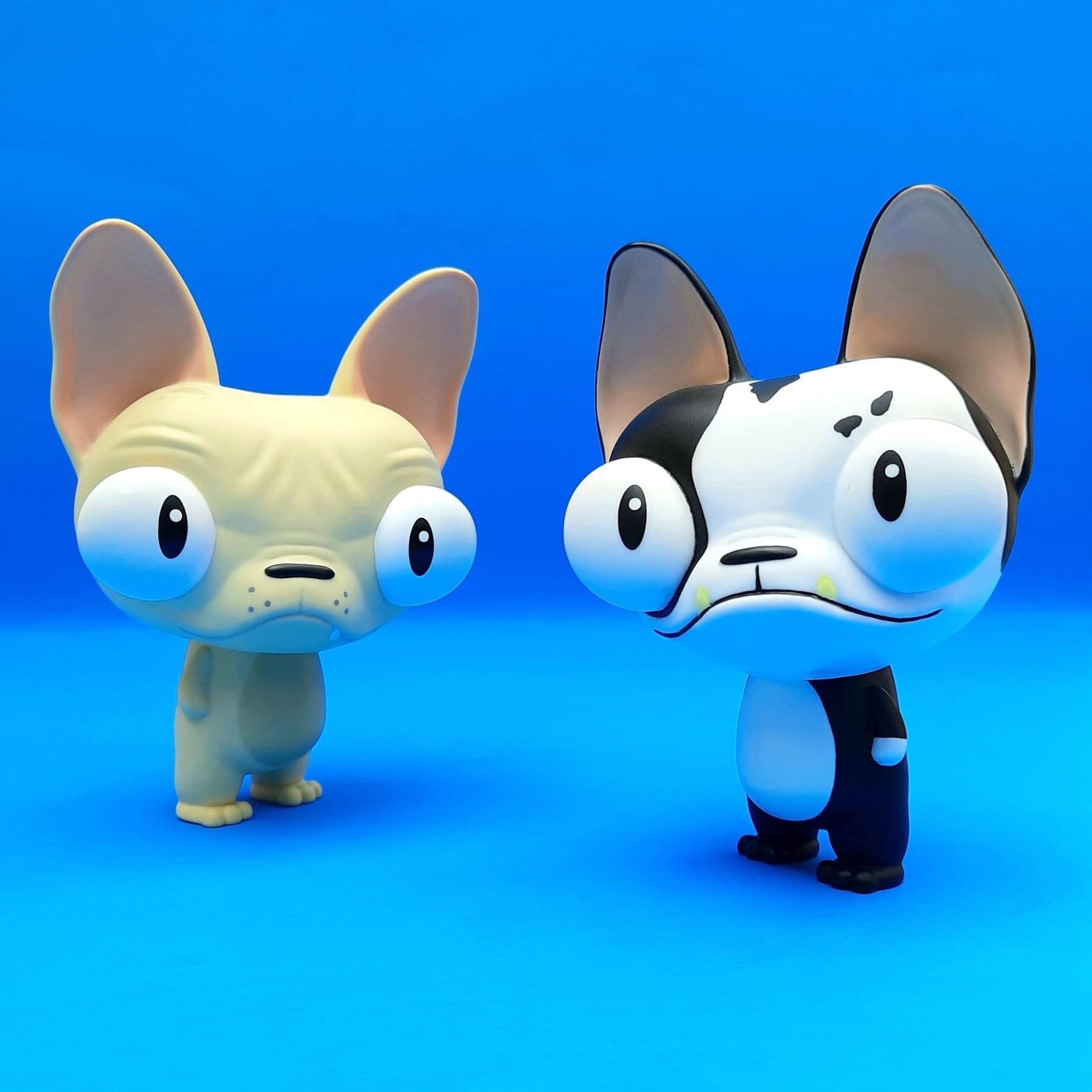 Toy dogs figurines, one with big eyes, close-up of cartoon eye and ear, and penguin figure.