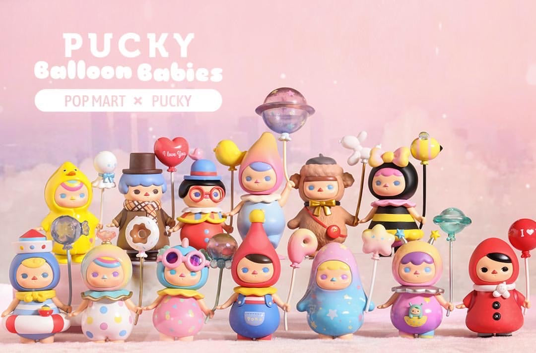Pucky Balloon Babies Series toy dolls and figures in a group with a monkey, hooded doll, and more.