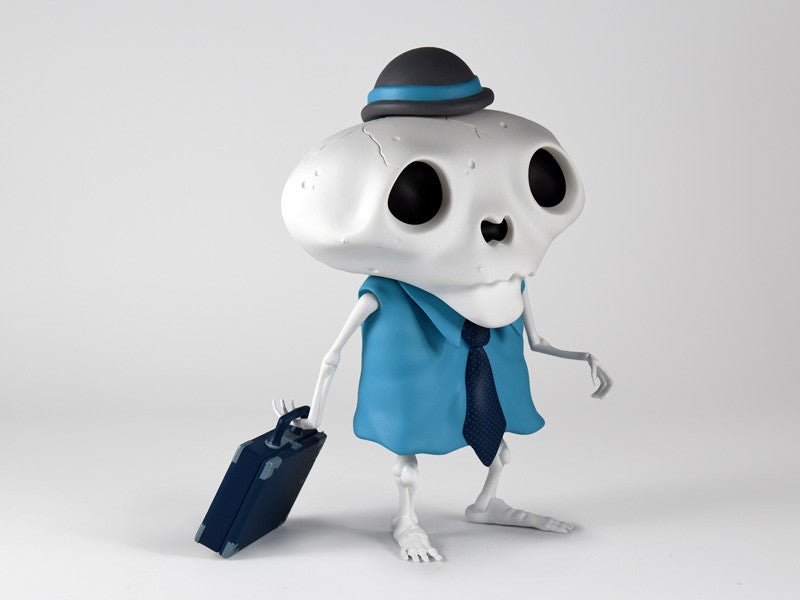 Karoshi San - Blue Collar Edition by Andrew Bell: Toy figure in suit and tie with briefcase, cartoon skeleton worker. Limited to 150 pieces.