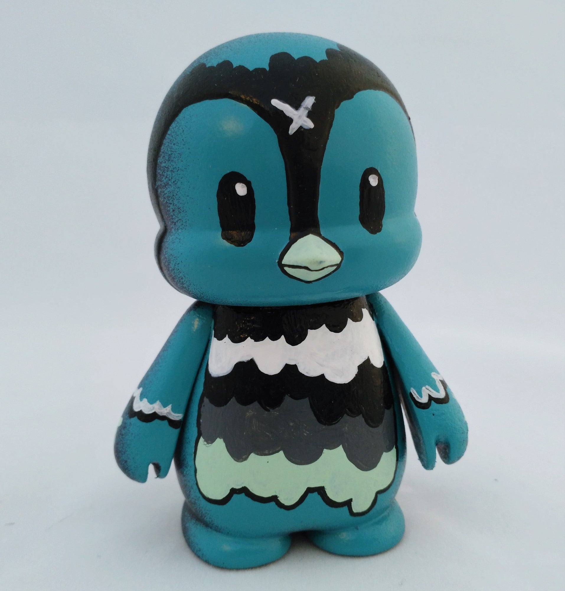 Custom Waddle figurine from Miles by Nicky Davis, featuring a cartoon animal with black and white paint details.
