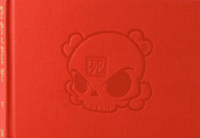 A red embossed skull on a book cover by artist Huck Gee.