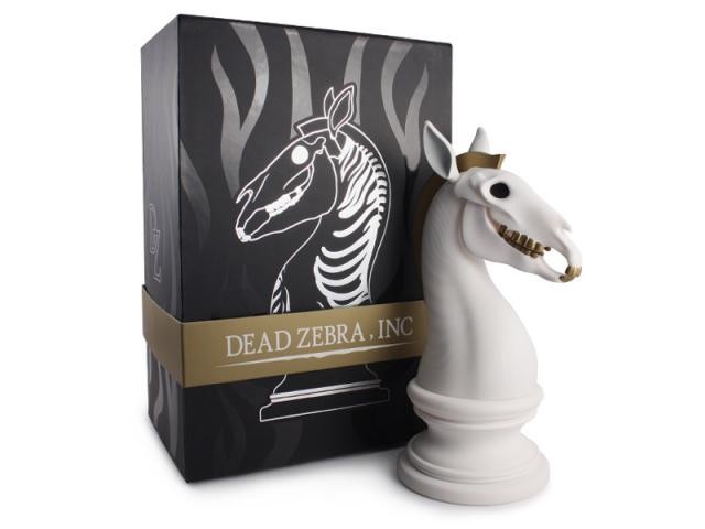The Last Knight vinyl figure next to a chess piece and box, embodying Dead Zebra, Inc design elements. Limited Edition.