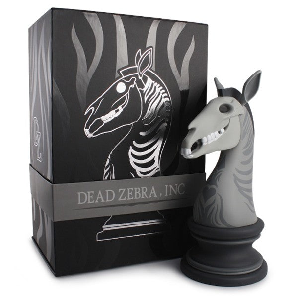 A skull-headed zebra vinyl figure resembling a knight chess piece with articulated jaw and ears, in a box with a horse head.
