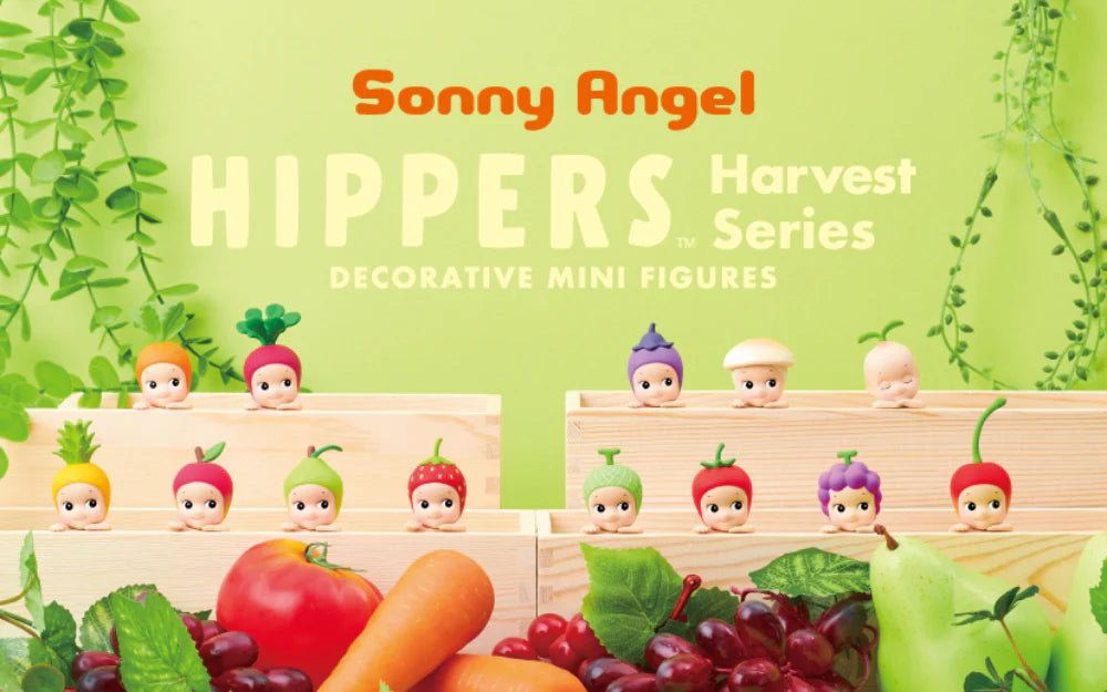 A group of small figurines in wooden boxes with fruits from Sonny Angels - HIPPERS Harvest Series.