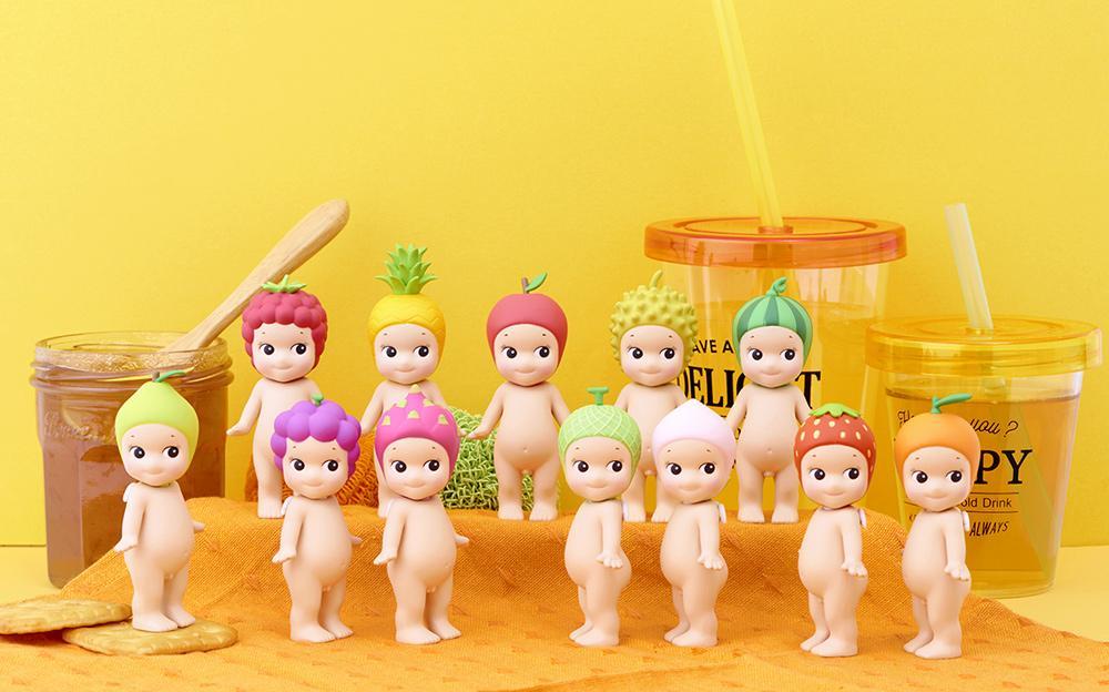 Sonny Angel - Fruit series: Small dolls and toy figurines in blind box lineup, featuring various figures including a doll and wooden spoon.