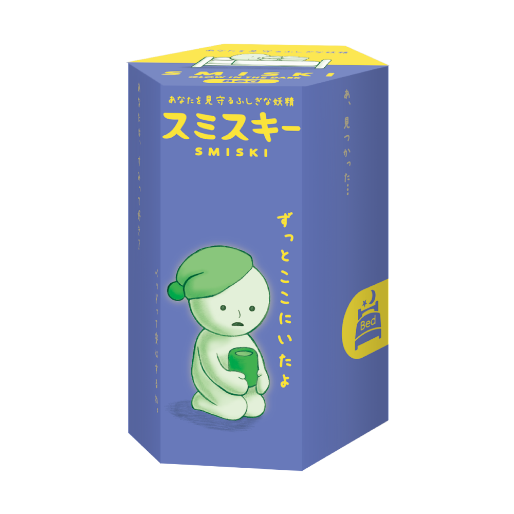 A box of a cartoon character from the SMISKI Bed Series, hiding in a bathroom corner, glowing mysteriously at night.